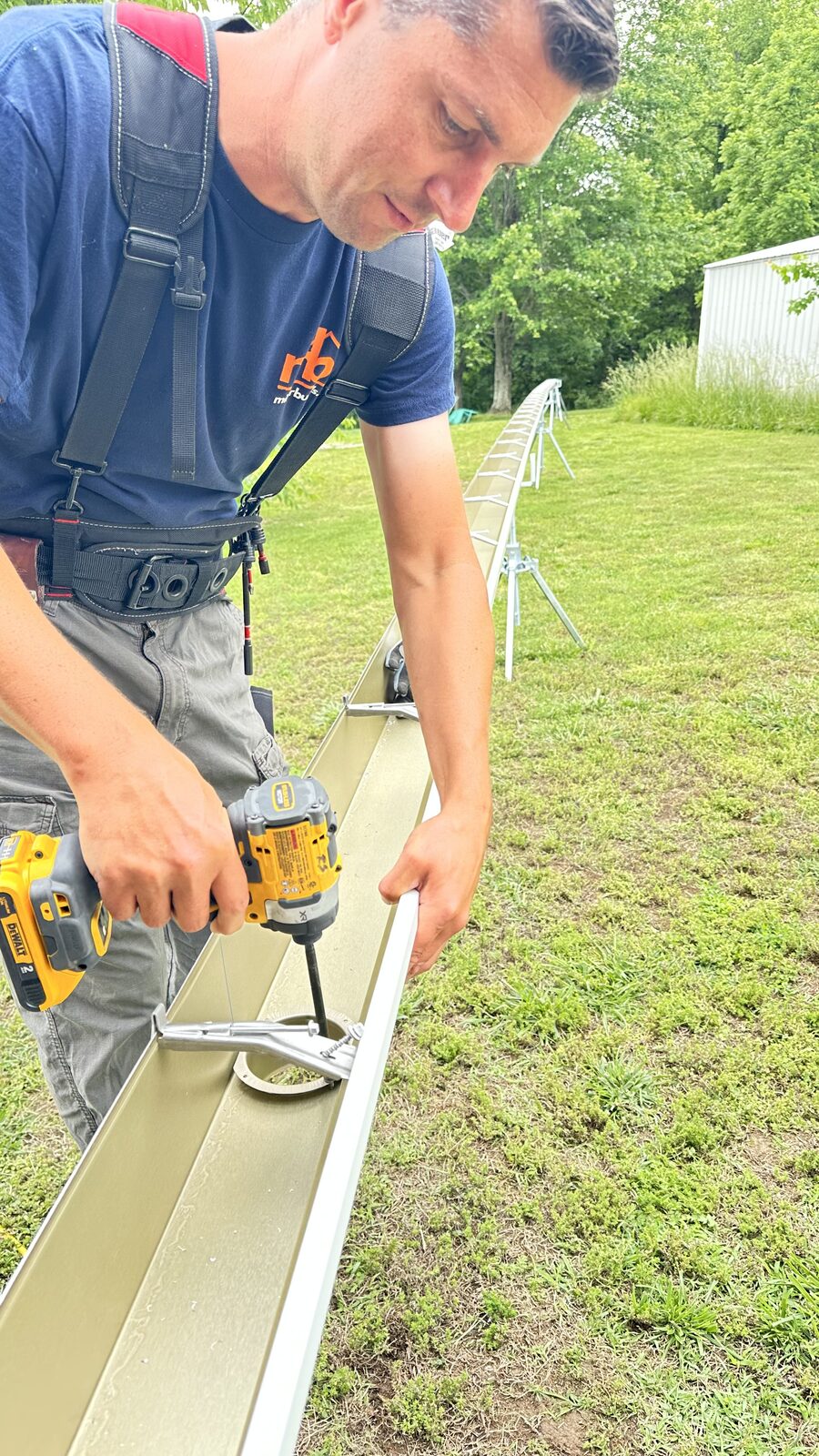 Miller Builds installer fastening a new seamless gutter section on site