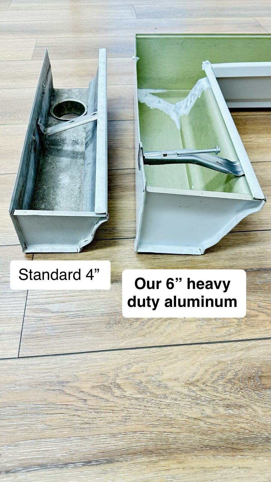 Comparison of a standard four inch gutter next to a six inch heavy duty aluminum gutter