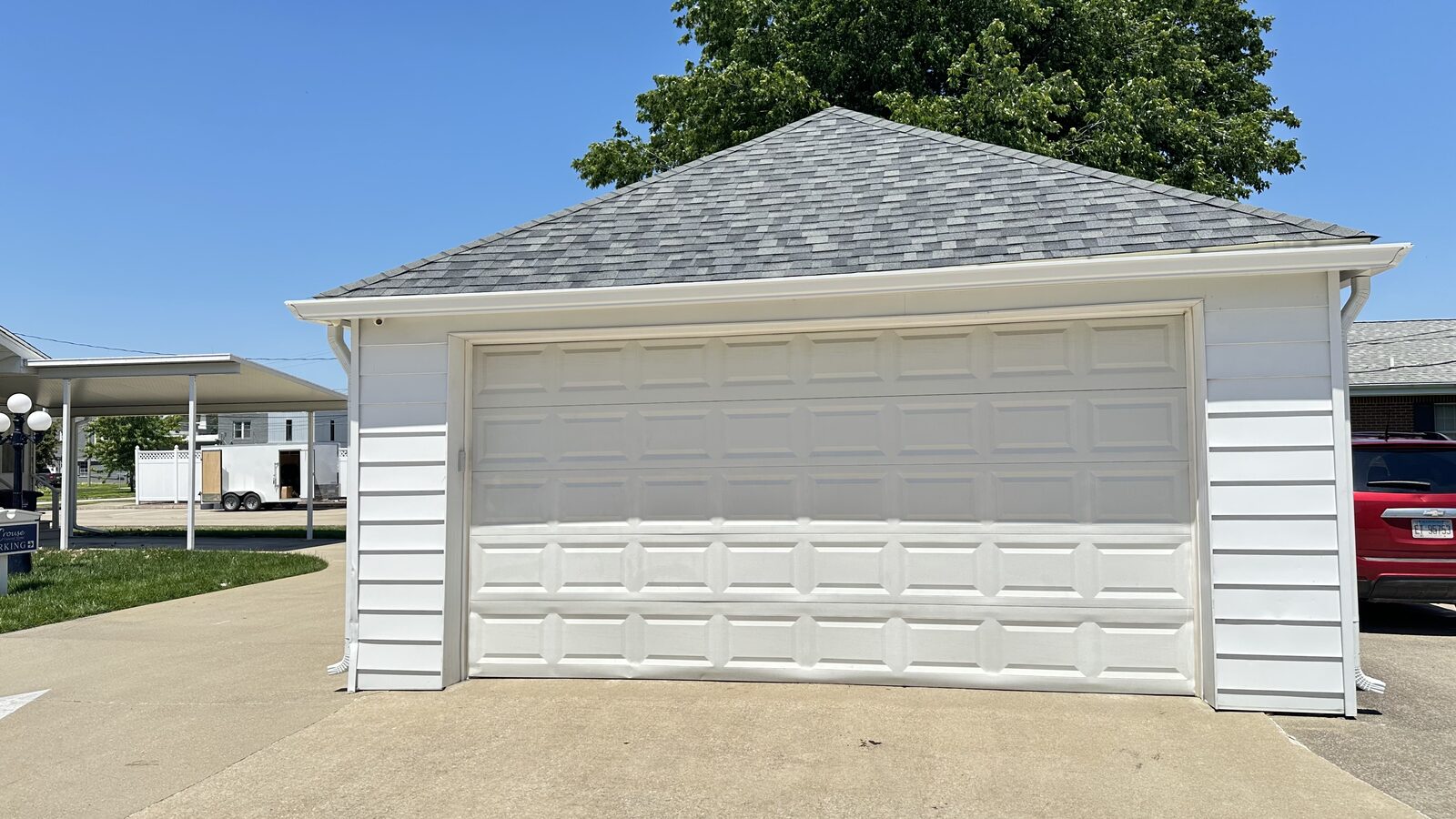 New white seamless gutters on a detached two car garage